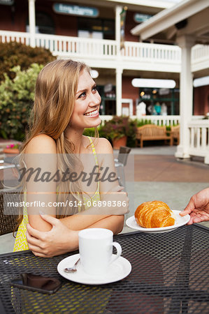 Woman being served croissant