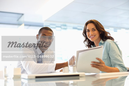 Portrait of smiling businessman and businesswoman working