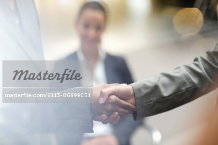 Close up of business people handshaking