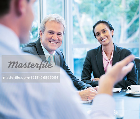 Smiling business people meeting in conference room