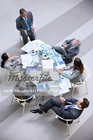 High angle view of businessman leading meeting