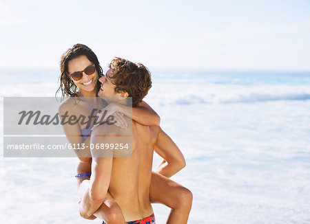 Happy couple hugging on beach