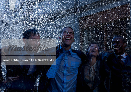 Enthusiastic businessmen in rain