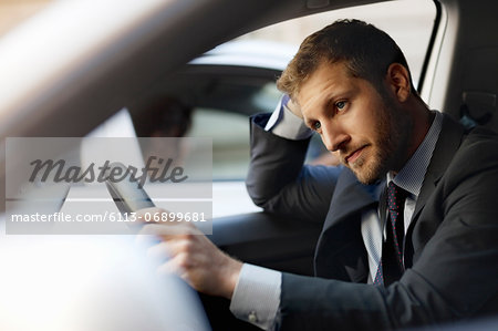 Unhappy businessman stuck in traffic inside car
