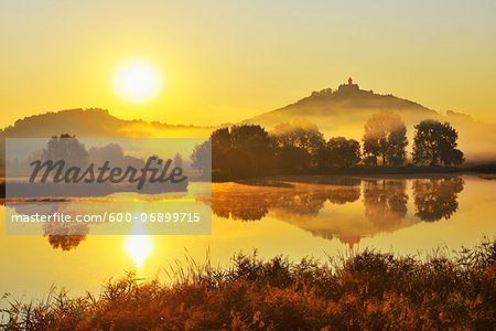 Wachsenburg Castle with Morning Mist and Sun reflecting in Lake at Dawn, Drei Gleichen, Thuringia, Germany