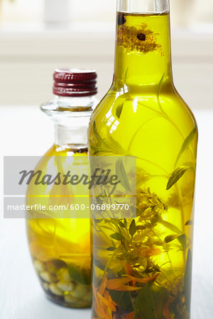 Still life of bottles of olive oil with herbs on window sill, Germany