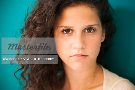 Close-up portrait of teenaged girl, looking at camera