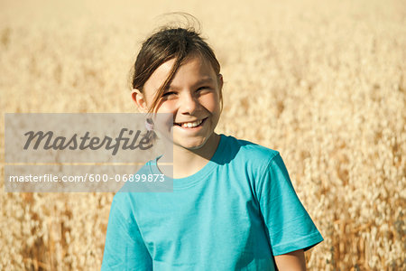 Portrait of girl standing in wheat field, Germany