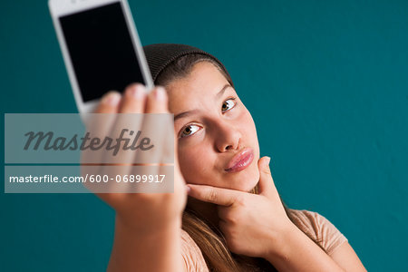 Girl taking picture of herself with smartphone, Germany