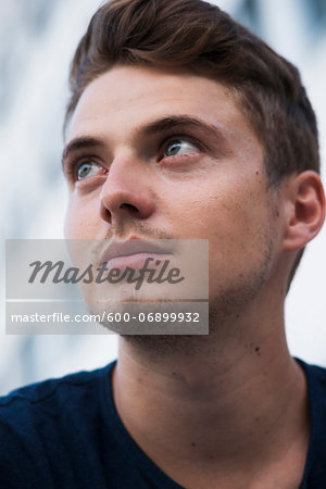 Close-up portrait of young man outdoors, Germany