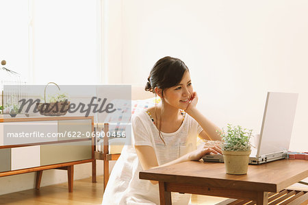 Young woman using PC in the living room