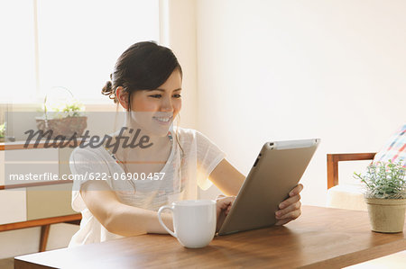 Young woman using tablet in the living room