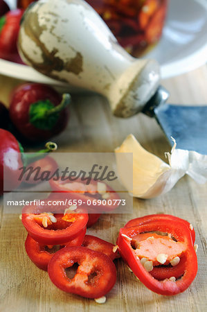 Sliced peppers and a mezzaluna knife in the background