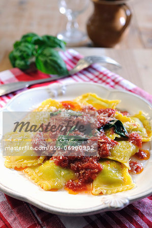 Spinach and ricotta filled ravioli pasta with tomato and fresh basil sauce