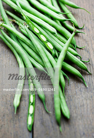 Green beans on a wooden background