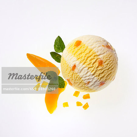 A scoop of apricot and yogurt ice cream, apricot wedges and lemon balm A scoop of apricot and yogurt ice cream, apricot wedges and lemon balm