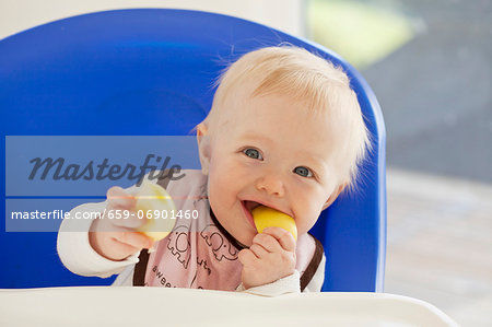 A baby eating an apple A baby eating an apple