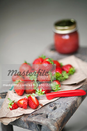 Fresh Strawberries on a Paper Bag; Knife; Jam