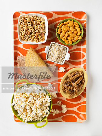 Assorted Grain Based Products: Taco Shells, Tortillas, Whole Grain Fusilli, Popcorn, Rice, Cereal and Goldfish Crackers