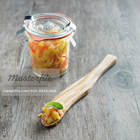 Jar of Homemade Mango Salsa; Some on a Wooden Spoon