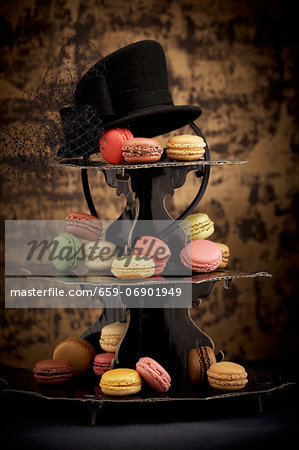 Macaroons on a tiered cake stand with a hat