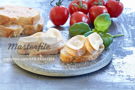 Baguette with soft cheese, basil and tomatoes Baguette with soft cheese, basil and tomatoes