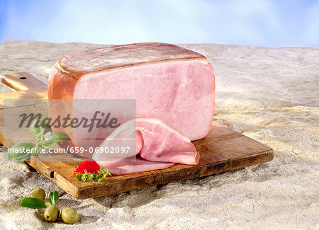 A boiled ham on a chopping board