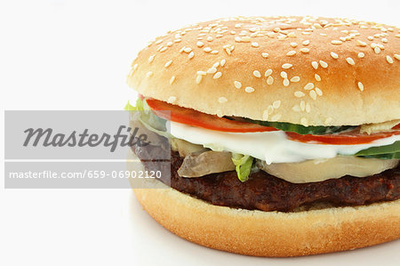 A hamburger with mushrooms, mozzarella and tomatoes A hamburger with mushrooms, mozzarella and tomatoes