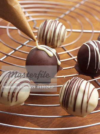 Decorating pralines with chocolate Decorating pralines with chocolate