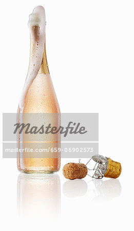 Pink champagne bubbling out the bottle