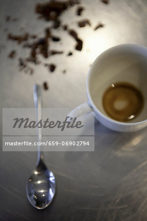 An espresso cup with the remains of a cup of coffee An espresso cup with the remains of a cup of coffee