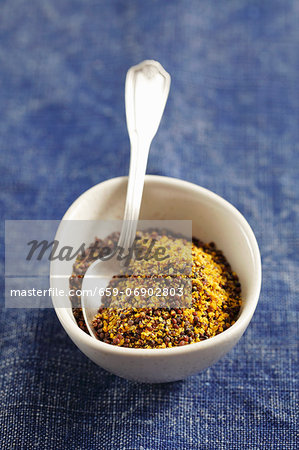 Ground black mustard seeds in a small bowl