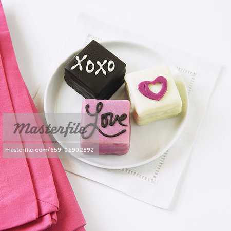 Three Assorted Mini One-Bite Valentine Cakes on a White Plate