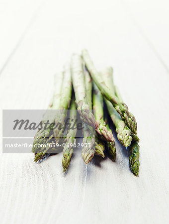 Green asparagus on a white wooden surface Green asparagus on a white wooden surface