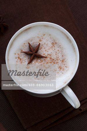 Cappuccino with Frothy Milk and Star Anise; From Above on a Black Background