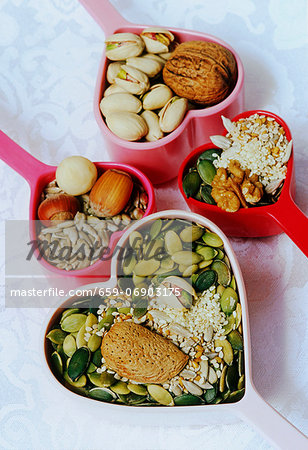 heart shaped measuring servers filled with pumpkin, sunflower and sesame seeds with hazlenuts, pistaccio, almonds and walnuts heart shaped measuring servers filled with pumpkin, sunflower and sesame seeds with hazlenuts, pistaccio, almonds and walnuts
