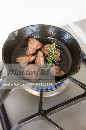 Wagyu beef with rosemary in a pan