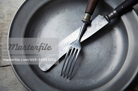 A tin plate with silver cutlery