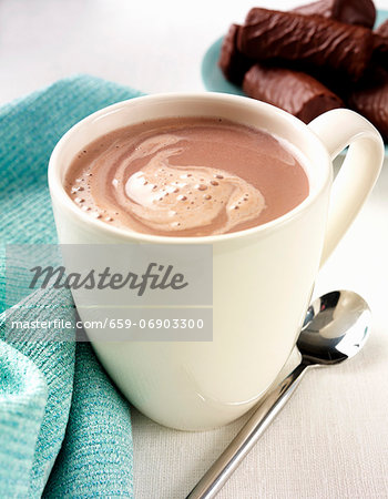 A mug of hot chocolate with chocolate biscuits