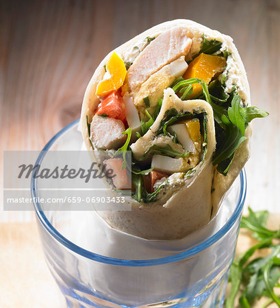 A wrap with chicken, yellow pepper, tomato, rocket, egg and cream cheese A wrap with chicken, yellow pepper, tomato, rocket, egg and cream cheese