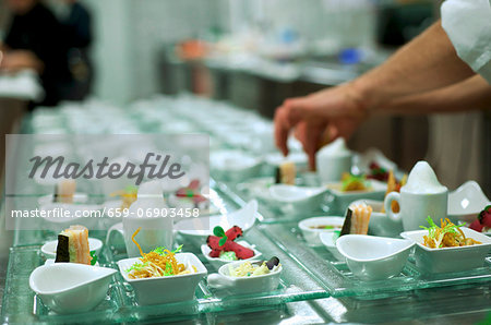 A chef arranging starters on a buffet A chef arranging starters on a buffet