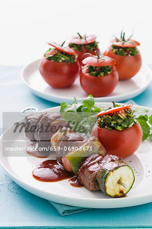 Beef skewers with vegetables and halloumi, and tomatoes stuffed with tabbouleh