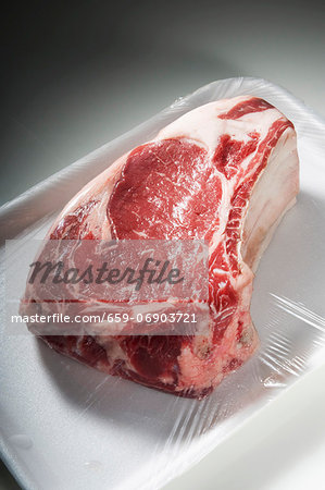 Bone-In Steak on Styrofoam Dish Wrapped in Plastic