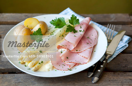 White asparagus and boiled ham with Hollandaise sauce and potatoes