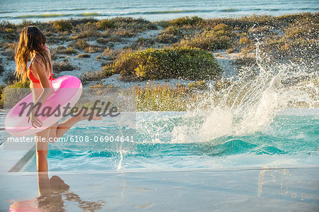 Woman enjoying in a swimming pool on the beach