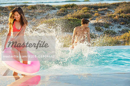 Couple enjoying in a swimming pool on the beach