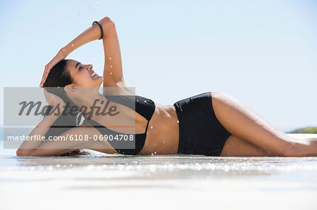 Beautiful woman in bikini posing on the beach