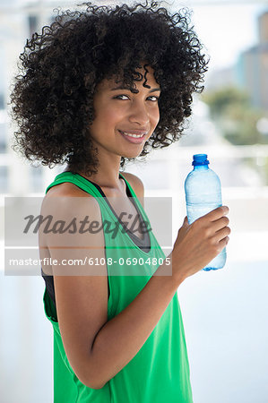 Portrait of a woman holding a water bottle and smiling