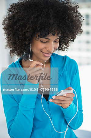 Smiling woman listening to music on a mobile phone