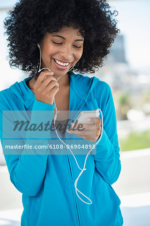 Smiling woman listening to music on a mobile phone